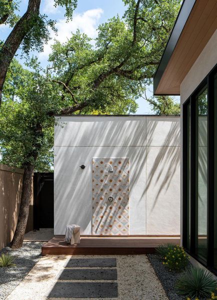 Outdoor pool shower perfectly situated in the backyard with a private entry to the pool bath.