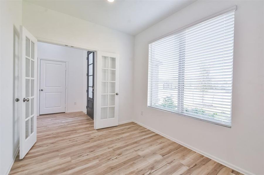 Double doors off the entryway lead into a versatile study ideal for working from home.