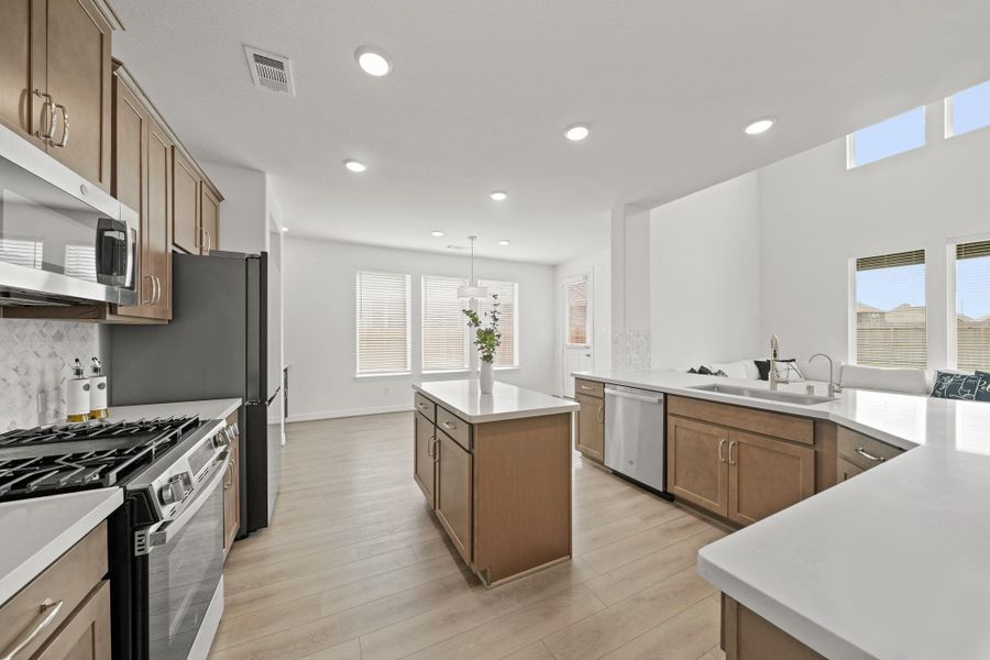 The well-appointed kitchen includes a center island and an adjoining breakfast/dining room.