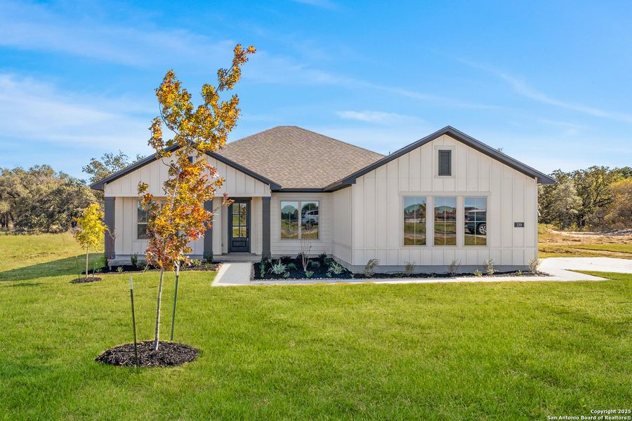 Front exterior of a new home in Pradera Ridge, Floresville, TX, highlighting curb appeal (Image 21). Front exterior of a new home in Pradera Ridge, Floresville, TX, highlighting curb appeal (Image 21).