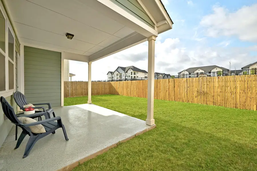 Fenced backyard featuring a patio and a residential view