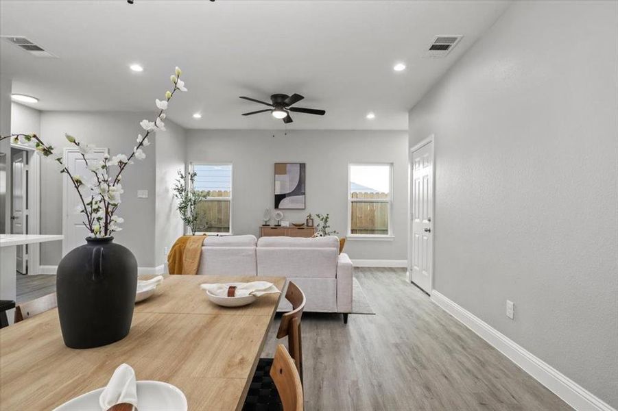 Dining room with ceiling fan and wood-type flooring