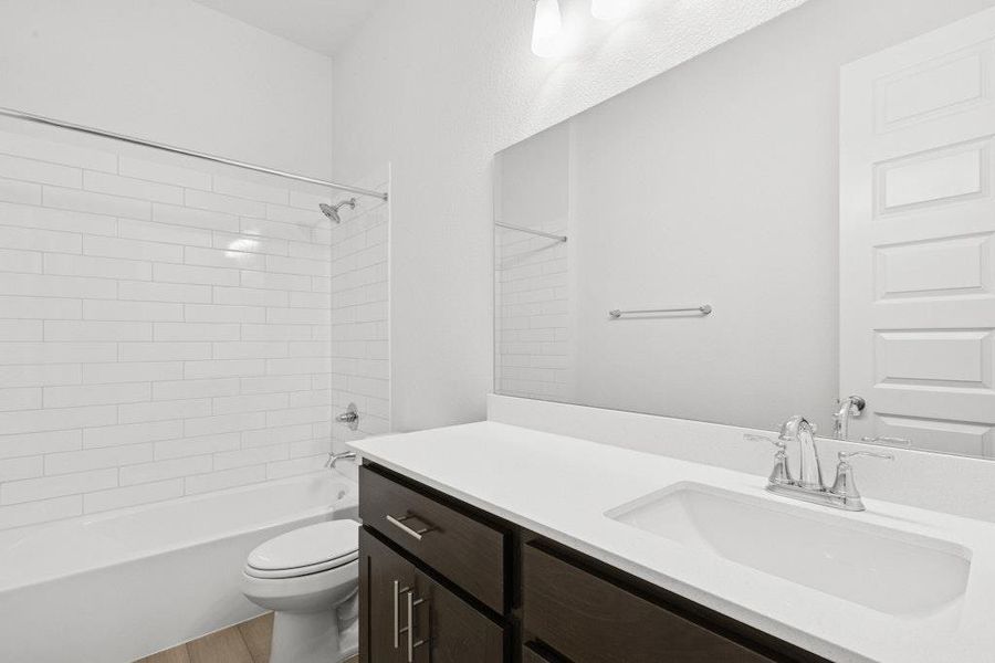 Bathroom featuring tub / shower combination and vanity Bathroom featuring tub / shower combination and vanity