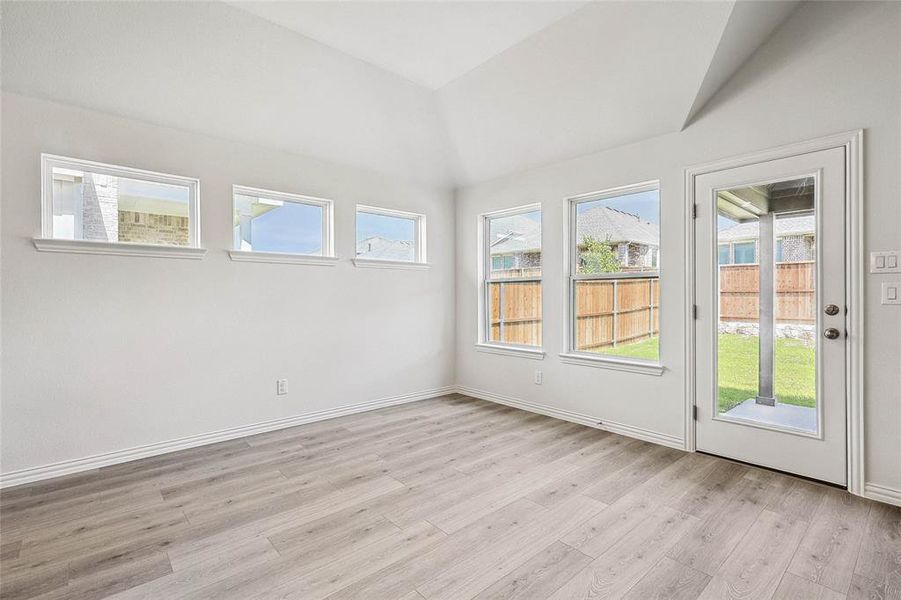 Unfurnished sunroom with lofted ceiling and a healthy amount of sunlight