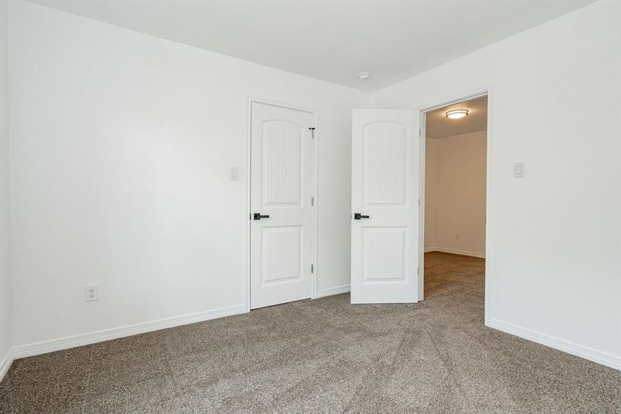 Unfurnished bedroom featuring carpet