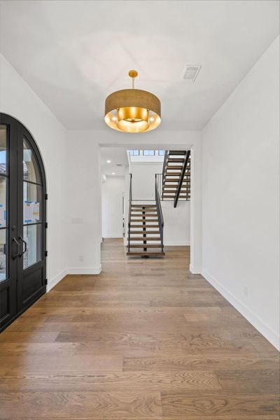 Foyer with french doors and dark wood-style flooring