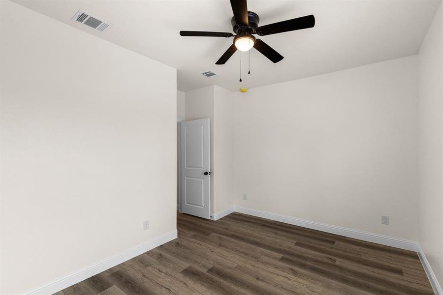 Spare room with ceiling fan and dark hardwood / wood-style flooring