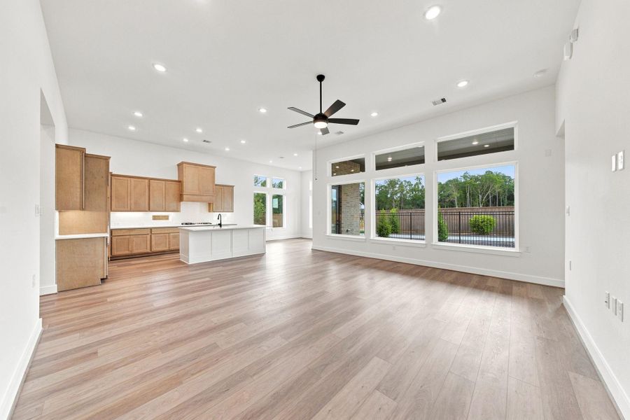 Bright, spacious open-concept living area with abundant windows, high ceilings, and seamless flow into the kitchen and dining spaces.