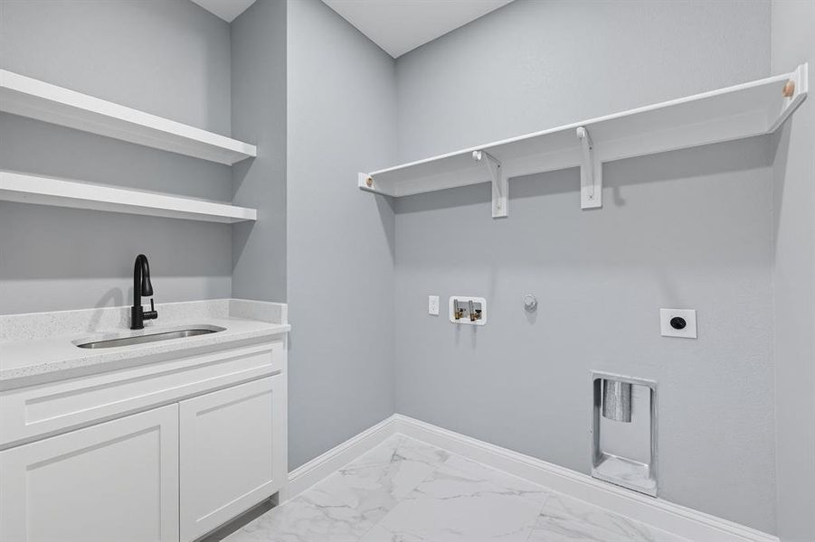 Washroom featuring gas dryer hookup, light marble finish floors, hookup for a washing machine, and electric dryer hookup Washroom featuring gas dryer hookup, light marble finish floors, hookup for a washing machine, and electric dryer hookup