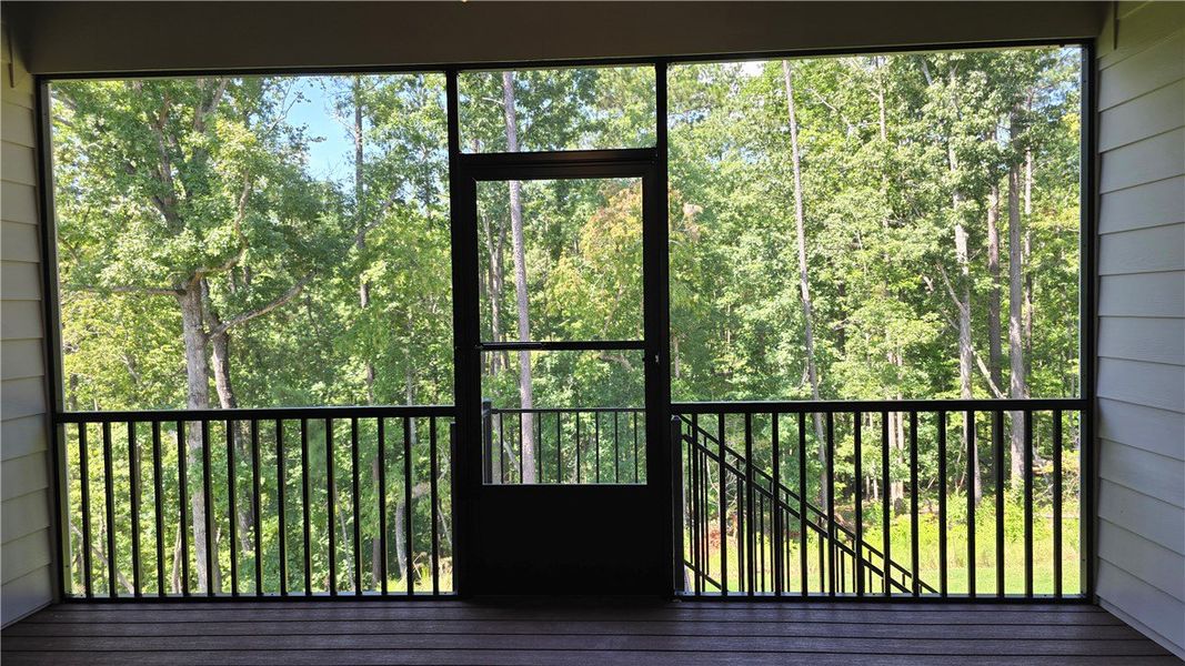 A tranquil screened porch offers verdant tree view