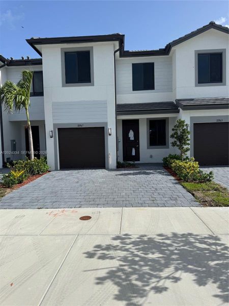 Front exterior of a new home in , Homestead, FL, highlighting curb appeal (Image 1). Front exterior of a new home in , Homestead, FL, highlighting curb appeal (Image 1).