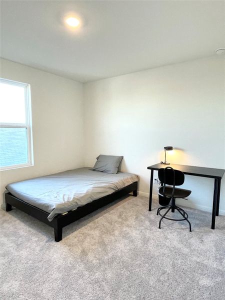 Carpeted bedroom with baseboards