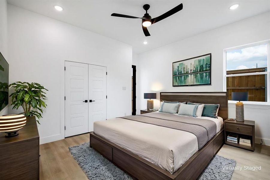 Bedroom featuring light wood finished floors, ceiling fan, a closet, and recessed lighting