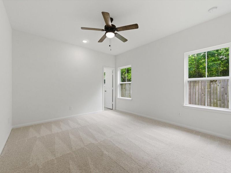 The main-level primary bedroom provides a quiet escape, thoughtfully positioned for both comfort and convenience.