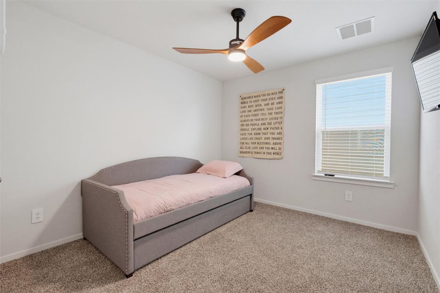 Plush carpeting and a classic multi-lite window define this versatile secondary bedroom space. Plush carpeting and a classic multi-lite window define this versatile secondary bedroom space.