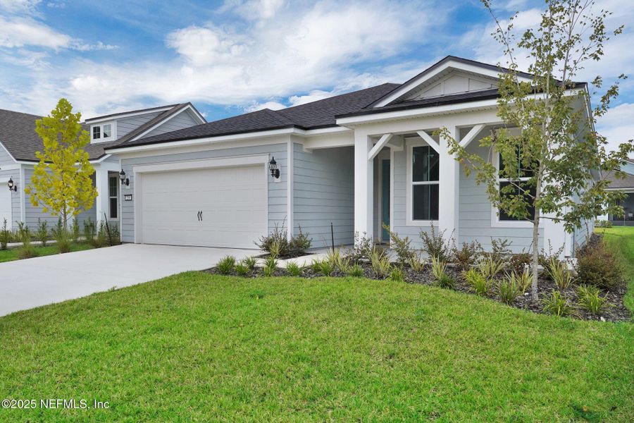 Front exterior of a new home in Summer Bay at Grand Oaks, St. Augustine, FL, highlighting curb appeal (Image 24).