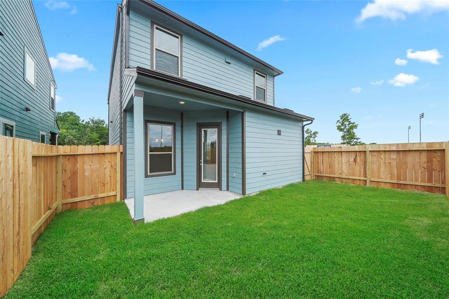 Large backyard with a covered patio