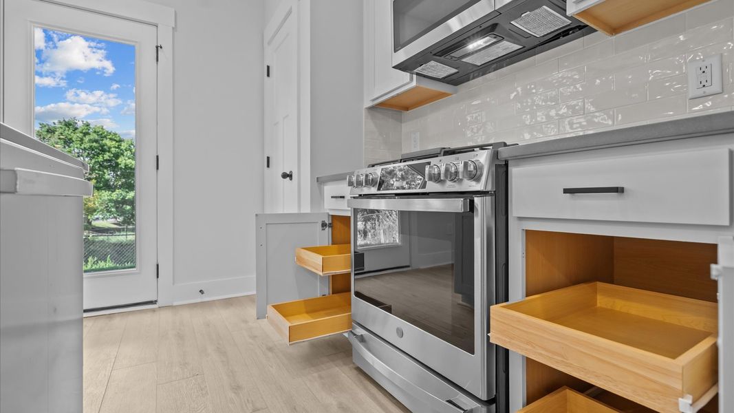 Tasteful kitchen with oversized island and stylish pendant lighting—crafted to high standards Tasteful kitchen with oversized island and stylish pendant lighting—crafted to high standards