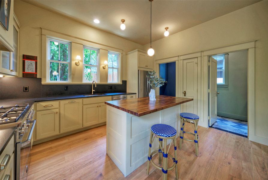 Culinary creations come to life in this spacious kitchen, featuring a wood-topped island and ample counter space.