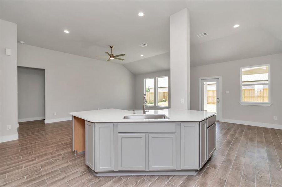 All of this overlooks your expansive family room, creating a perfect space for culinary delights and family gatherings. Sample photo of completed home. Actual colors and selections may vary.