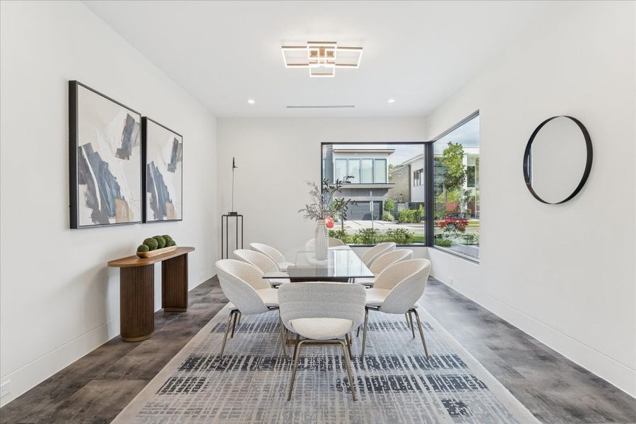 Elegant formal dining room with modern decor, abundant natural light, and a stylish ambiance perfect for entertaining.