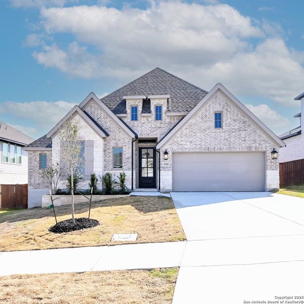 Front exterior of a new home in Homestead 65', Schertz, TX, highlighting curb appeal (Image 20).