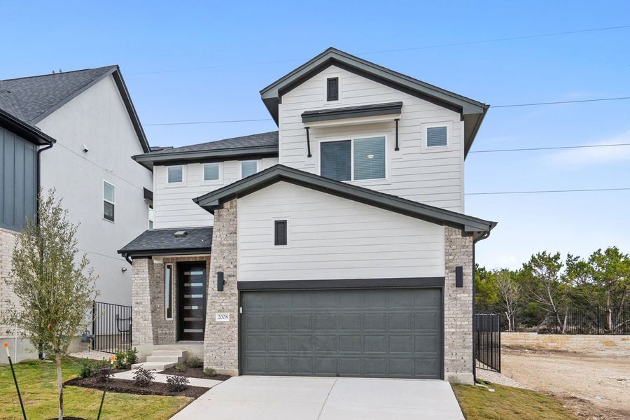Front exterior of a new home in Foxfield, Austin, TX, highlighting curb appeal (Image 1). Front exterior of a new home in Foxfield, Austin, TX, highlighting curb appeal (Image 1).
