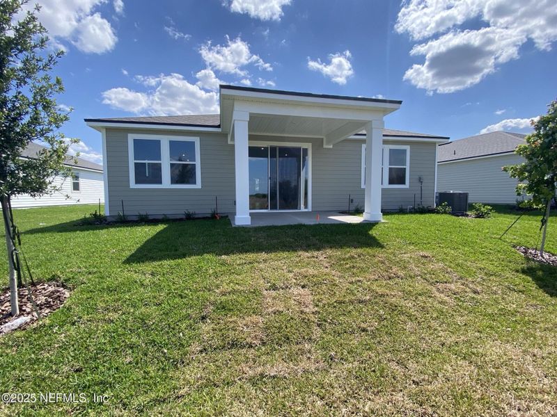 Front exterior of a new home in Lakes at Bella Lago, Green Cove Springs, FL, highlighting curb appeal (Image 2).