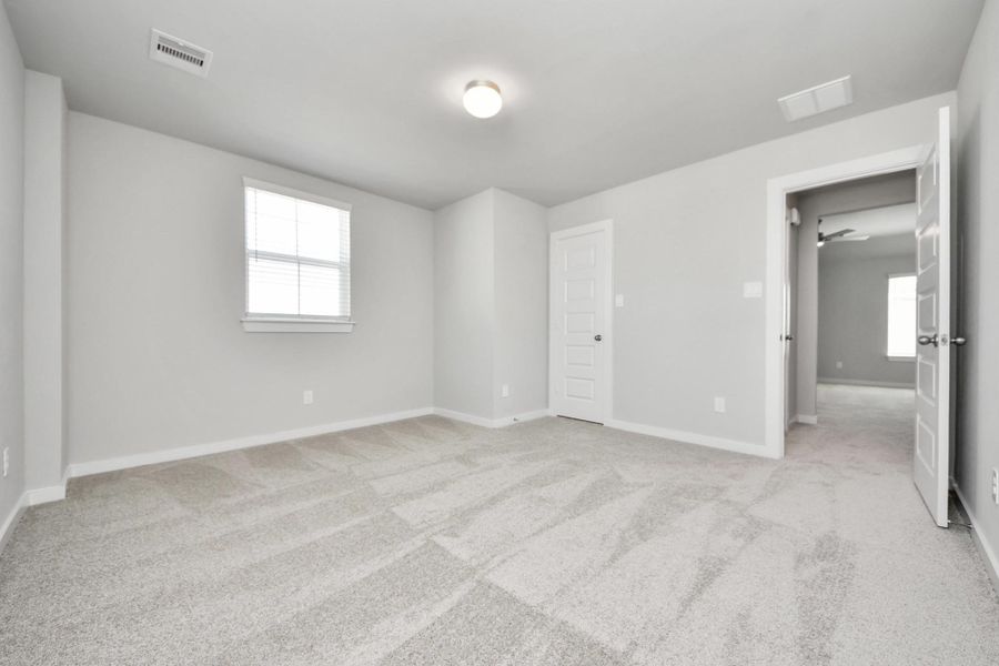 Generously sized secondary bedrooms featuring spacious closets, soft and inviting carpeting underfoot, large windows allowing plenty of natural light, and the added touch of privacy blinds for your personal retreat. Sample photo of completed home with similar floor plan. Actual colors and selections may vary.
