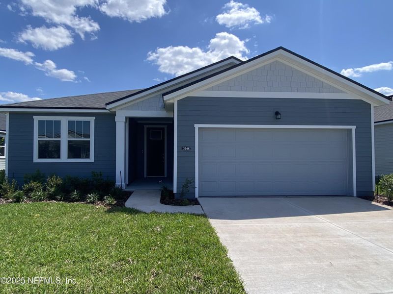 Front exterior of a new home in Lakes at Bella Lago, Green Cove Springs, FL, highlighting curb appeal (Image 1). Front exterior of a new home in Lakes at Bella Lago, Green Cove Springs, FL, highlighting curb appeal (Image 1).
