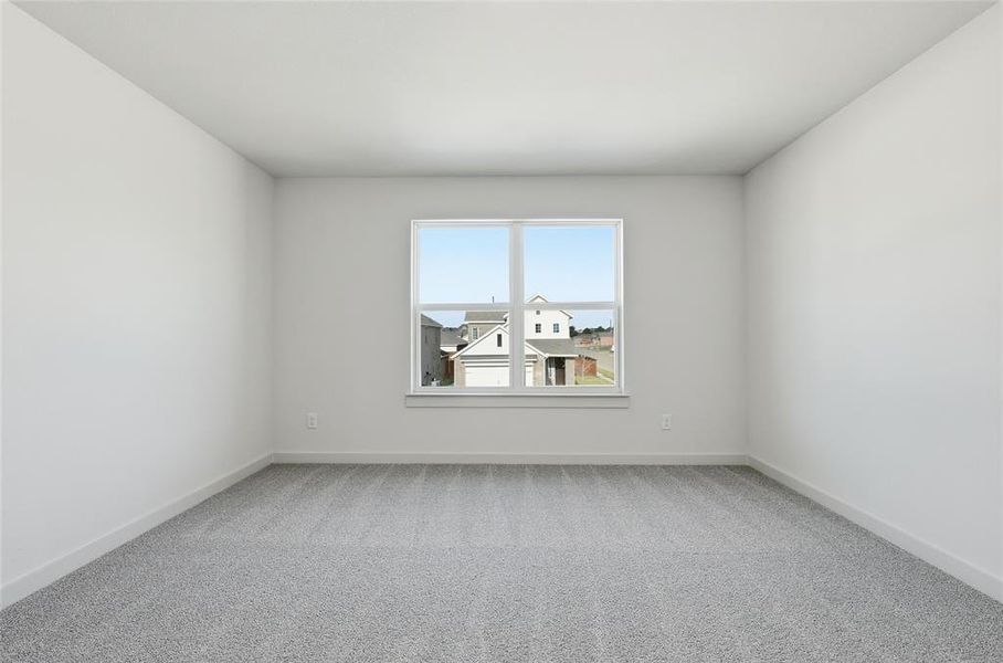 Empty room with light colored carpet and baseboards Empty room with light colored carpet and baseboards