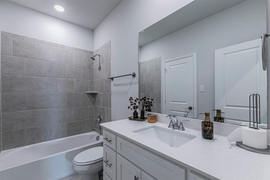 Bathroom with vanity and bathing tub / shower combination Bathroom with vanity and bathing tub / shower combination