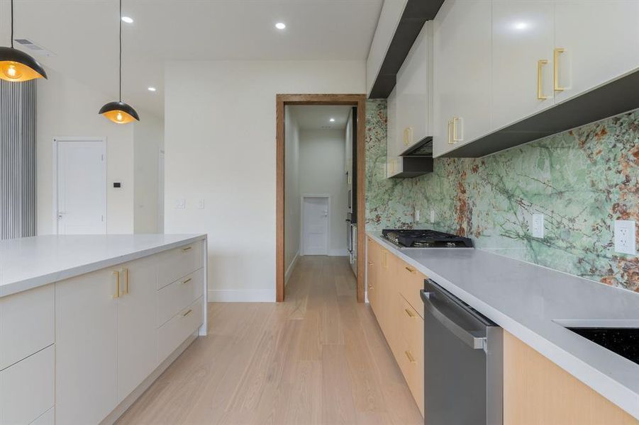 Kitchen featuring hanging light fixtures, white cabinets, modern cabinets, and recessed lighting