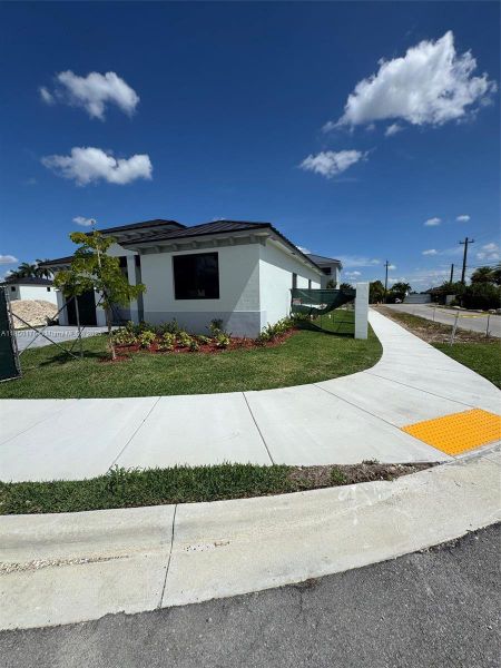 Front exterior of a new home in , Homestead, FL, highlighting curb appeal (Image 9). Front exterior of a new home in , Homestead, FL, highlighting curb appeal (Image 9).