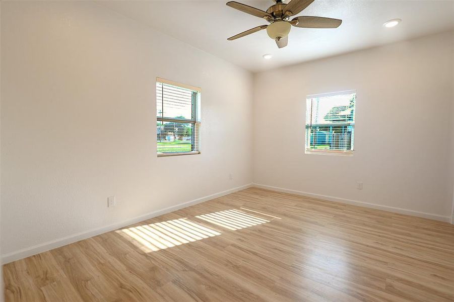 Spare room with light wood-style flooring, ceiling fan, and recessed lighting