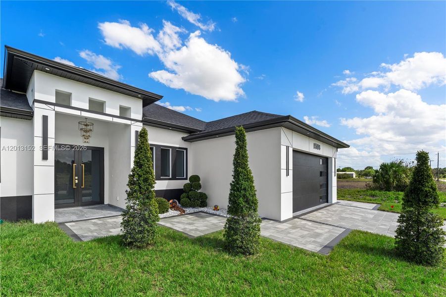 Front exterior of a new home in , Lehigh Acres, FL, highlighting curb appeal (Image 28).