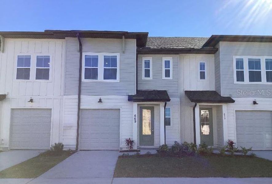 Front exterior of a home in the The Enclaves at Festival Cove community, located in Davenport, FL (Image 9).