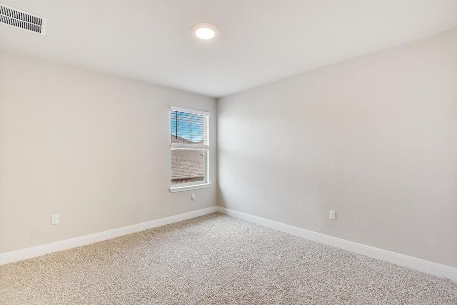 Spare room with carpet floors, baseboards, and visible vents