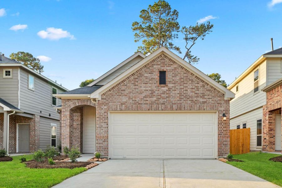 Front exterior of a new home in Woodland Lakes, Huffman, TX, highlighting curb appeal (Image 1). Front exterior of a new home in Woodland Lakes, Huffman, TX, highlighting curb appeal (Image 1).