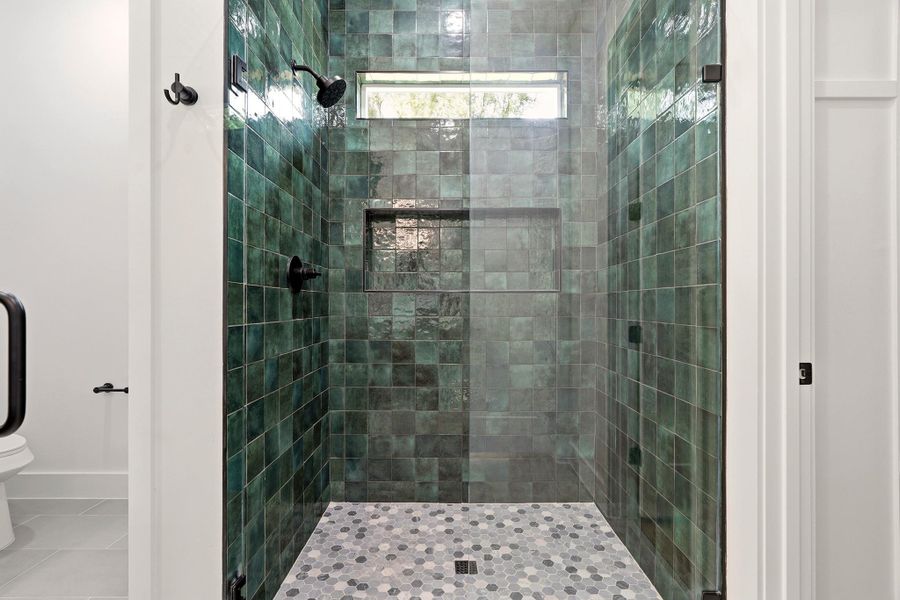 Full bath featuring a shower stall and tile patterned floors