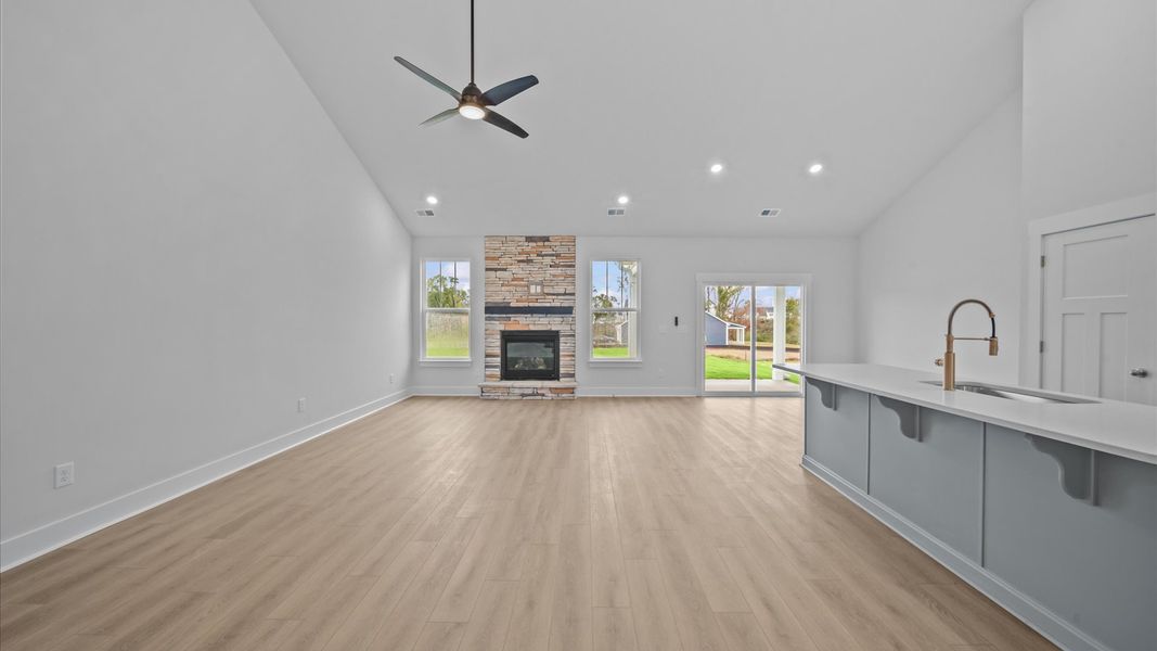 Vibrant family room with high-impact two-story ceilings and thoughtful layout for entertaining Vibrant family room with high-impact two-story ceilings and thoughtful layout for entertaining