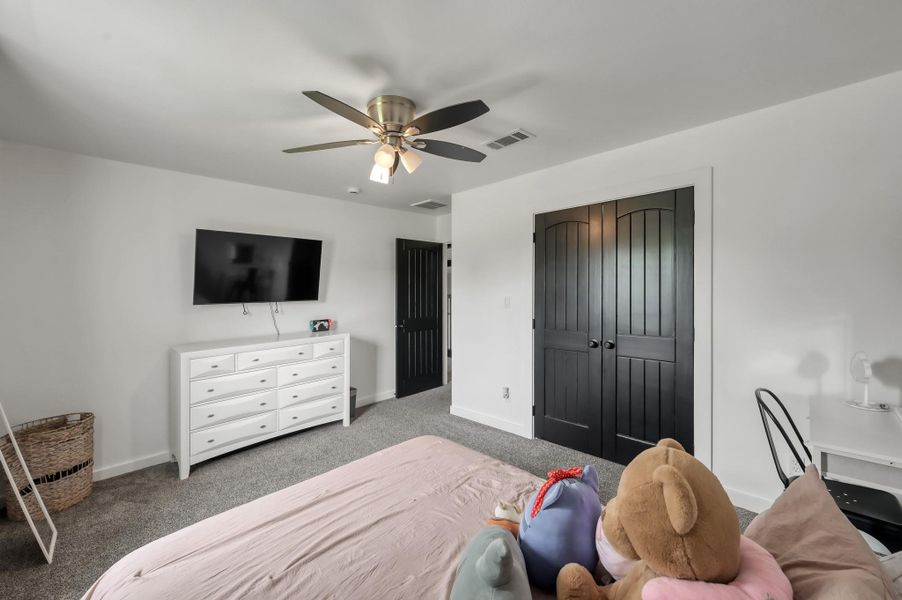 Bedroom #2 is cozy and well-lit, featuring a ceiling fan, carpeted flooring, and neutral walls creating a comfortable, inviting space.