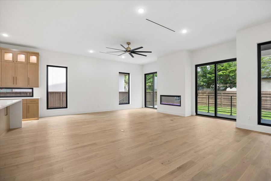 There is a super sized fan in the open living area which is anchored by the central fireplace.