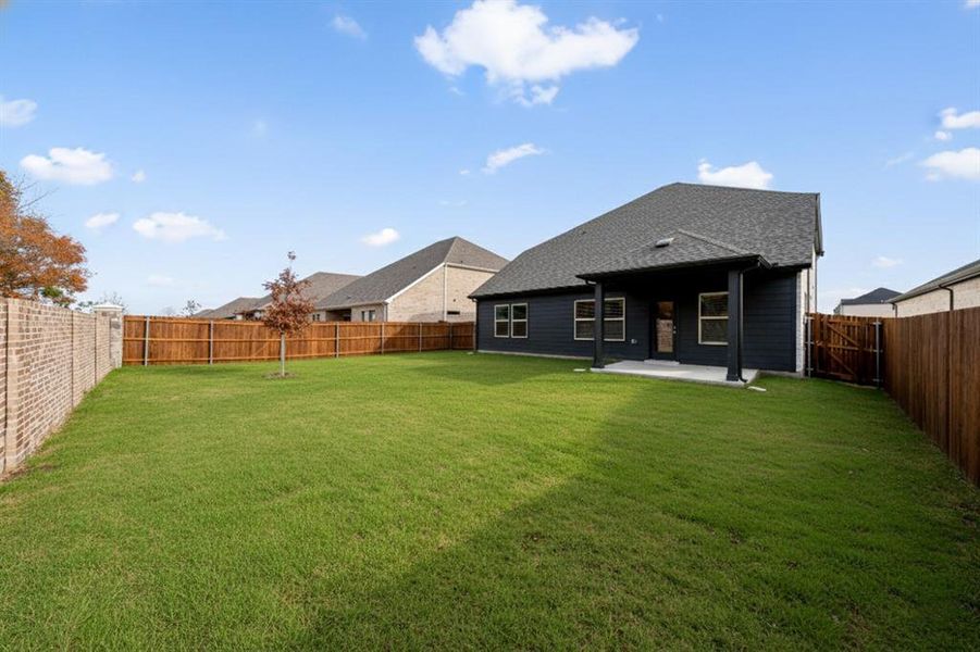 Rear view of house featuring a patio area, a fenced backyard, and a shingled roof Rear view of house featuring a patio area, a fenced backyard, and a shingled roof