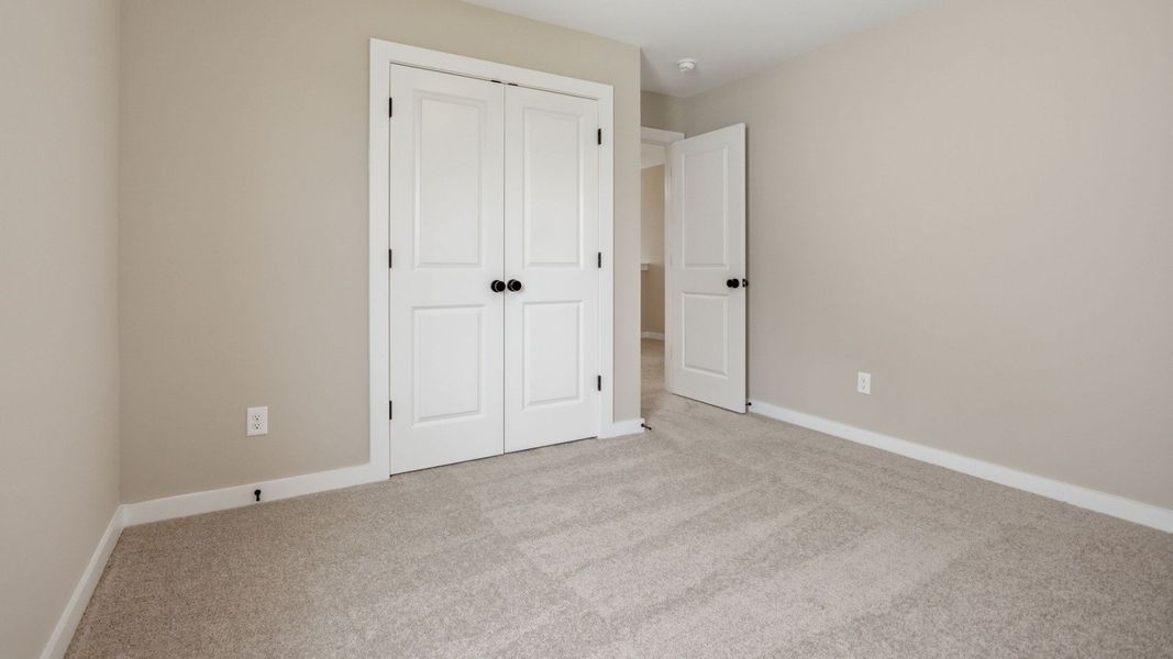 Bedroom with closet and access to loft area Bedroom with closet and access to loft area