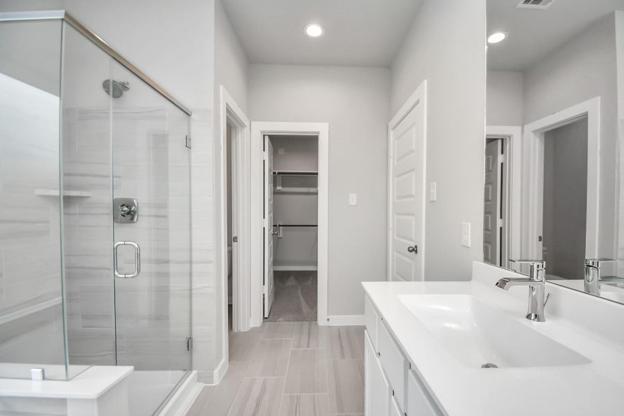 Discover another perspective of the luxurious primary bathroom. Sample photo of completed home with similar floor plan. Actual colors and selections may vary.