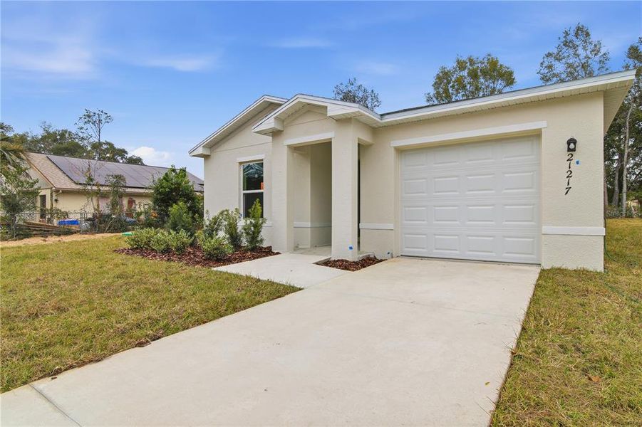 Front exterior of a new home in Rainbow Lakes Estates, Dunnellon, FL, highlighting curb appeal (Image 17). Front exterior of a new home in Rainbow Lakes Estates, Dunnellon, FL, highlighting curb appeal (Image 17).