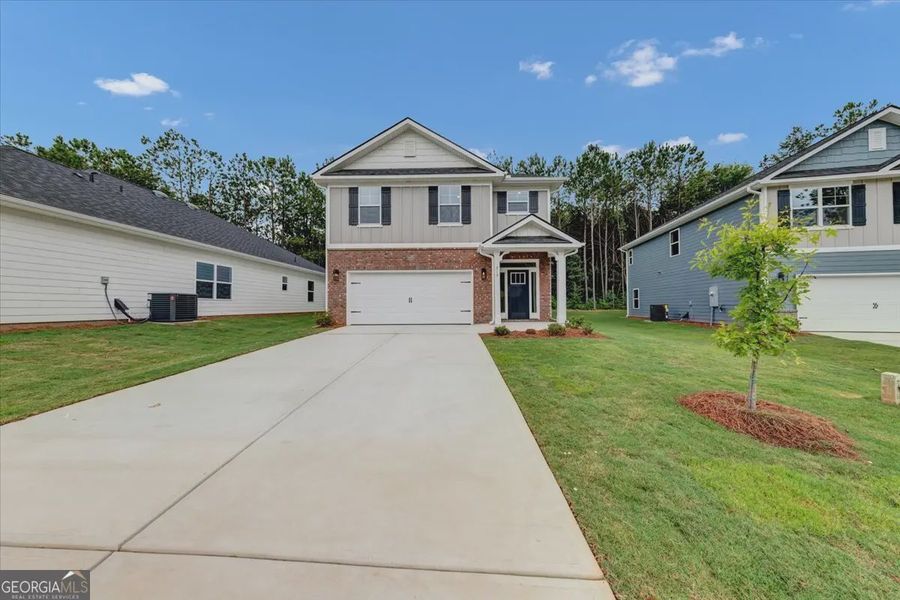 Front exterior of a new home in Canterbury Villas, Carrollton, GA, highlighting curb appeal (Image 2). Front exterior of a new home in Canterbury Villas, Carrollton, GA, highlighting curb appeal (Image 2).