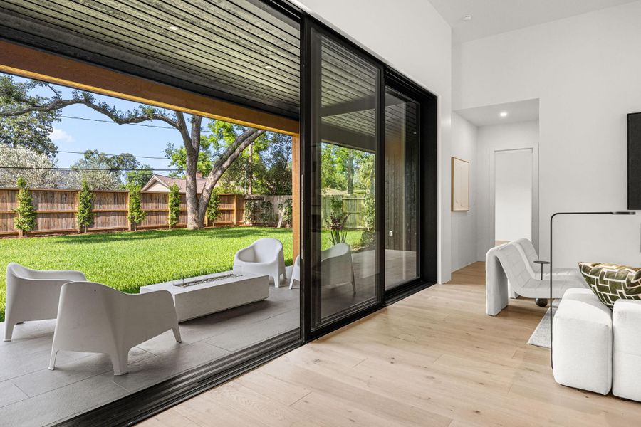 A Stately wall of sliding windows opens from the Family Room to the extra large covered patio, which is pre-plumbed for a summer kitchen.