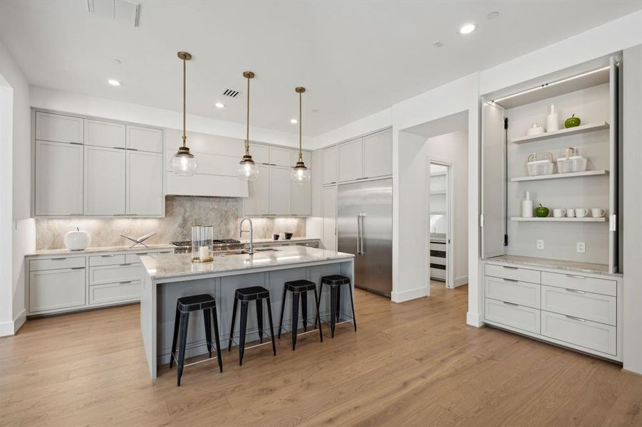 The gorgeous shelving on the right opens up and displays your favorite kitchen items, dishes and more. You also have drawers that provide even more storage.